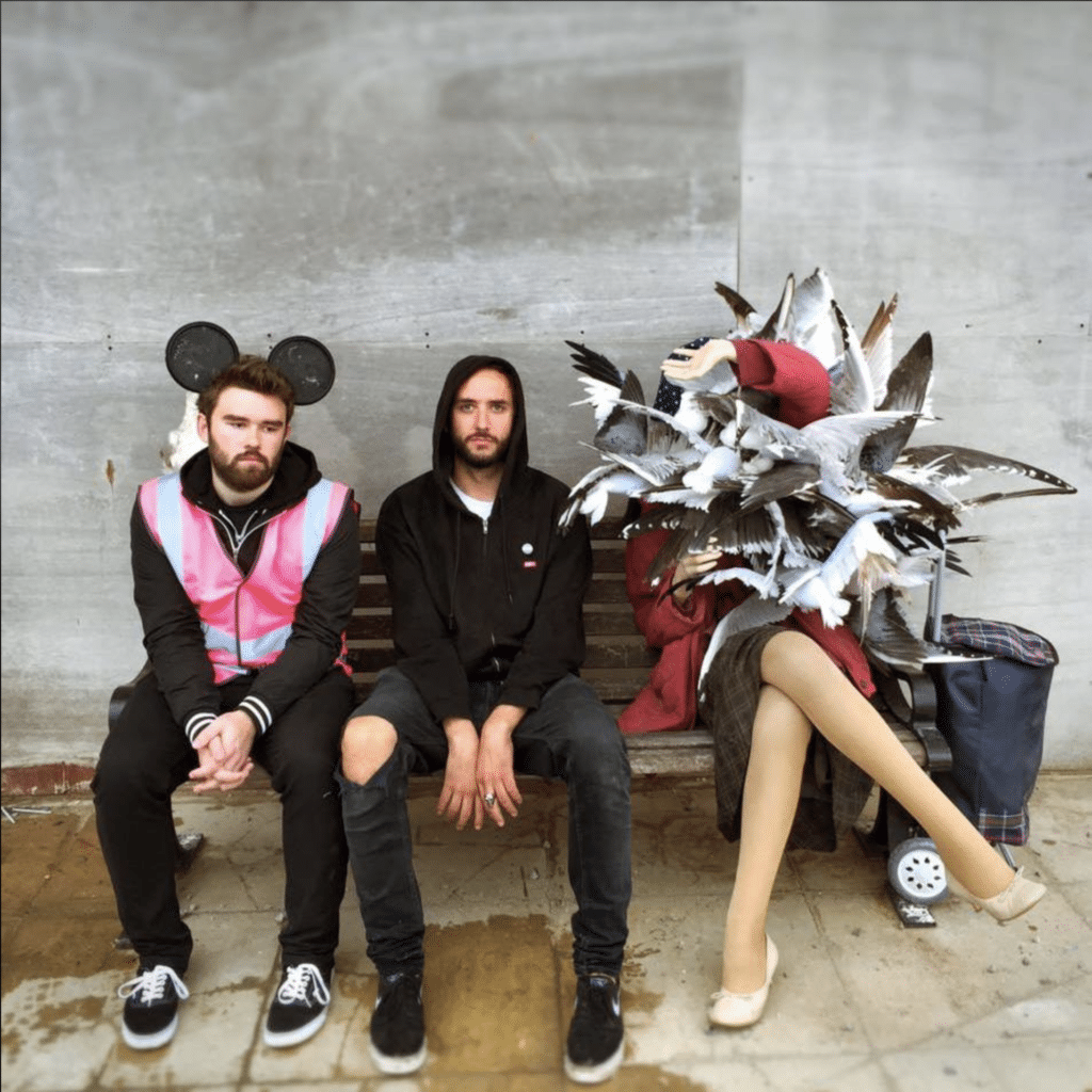 Doug Gillen sits beside Banksy’s sculpture of a woman being swarmed by seagulls at Dismaland